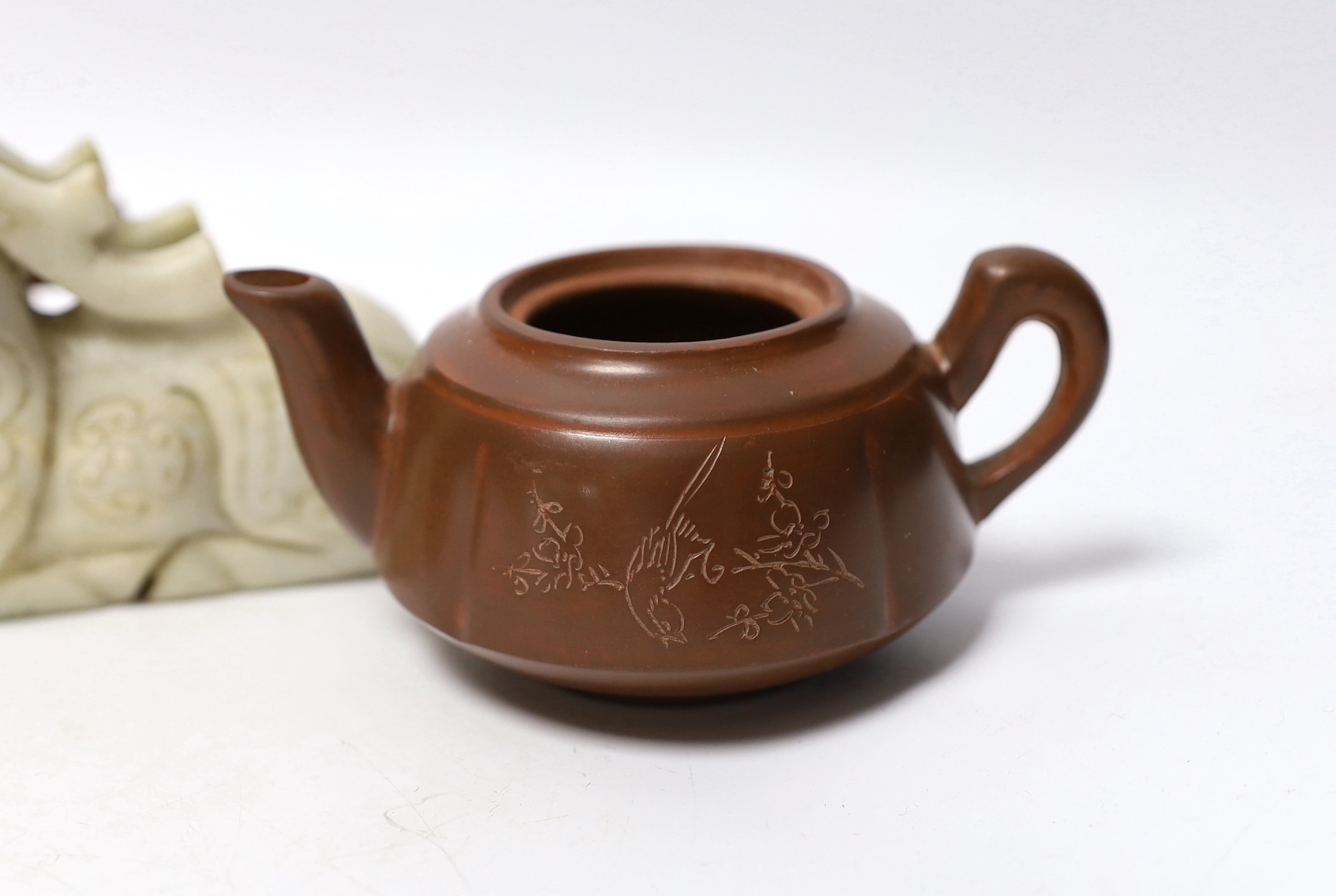 Eleven Chinese items including four Yixing pottery teapots, a stone disc, a jade horse and five miniature bowls, tallest teapot 6.5cm